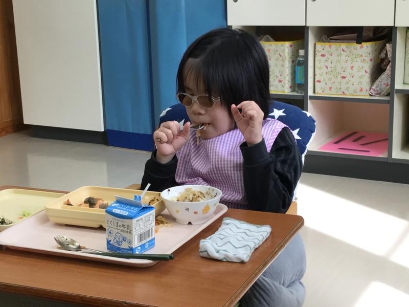 おいしそうに給食を食べる生徒